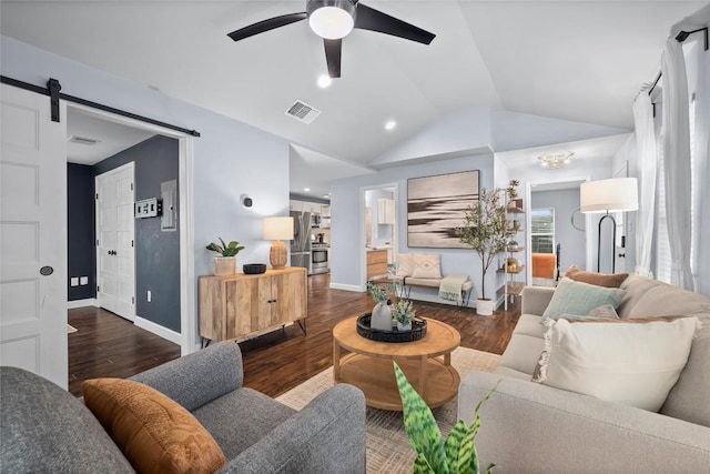 1191 Chicon St, Austin, TX 78702 - living room with wood finished floors, a ceiling fan, vaulted ceiling, a barn door, and recessed lighting