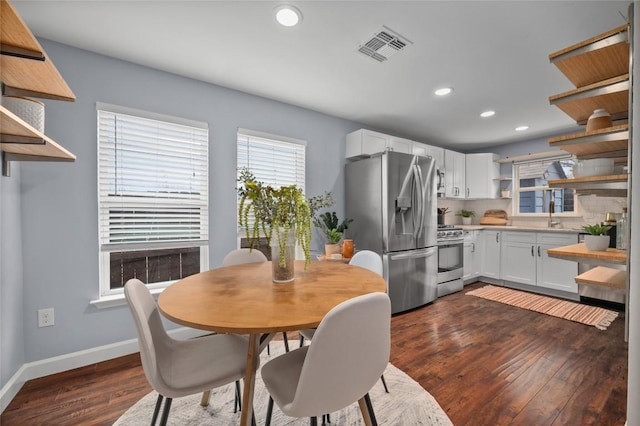 dining area featuring sink and dark hardwood / wood-style flooring