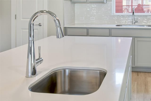 5812 Rotunda Vw, Austin, TX 78747 - kitchen view of a sink, gray cabinetry, and light countertops