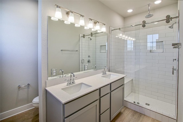 5812 Rotunda Vw, Austin, TX 78747 - bathroom with wood finished floors, a stall shower, double vanity, and recessed lighting