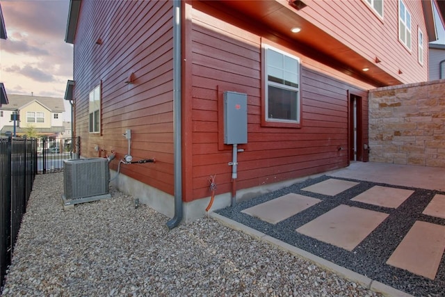 5812 Rotunda Vw, Austin, TX 78747 - view of side of property with central AC and a patio