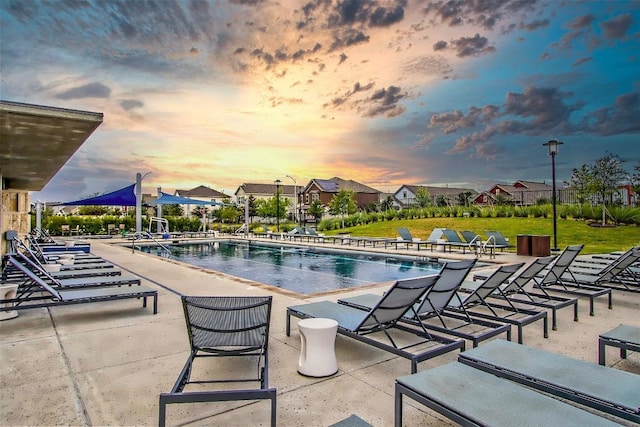 5812 Rotunda Vw, Austin, TX 78747 - pool at dusk featuring a community pool and a patio area