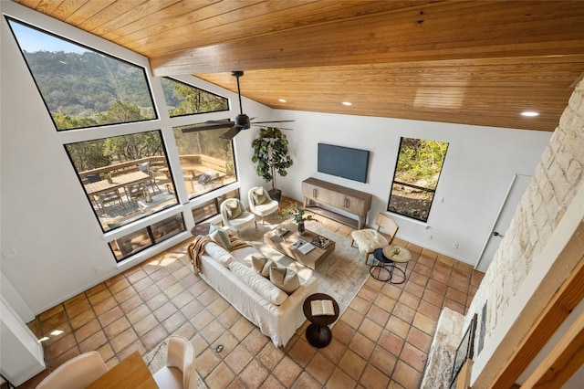 tiled living room featuring ceiling fan, lofted ceiling, a wealth of natural light, and wood ceiling