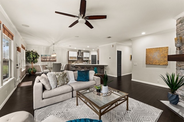 living room featuring hardwood / wood-style flooring, ornamental molding, and ceiling fan