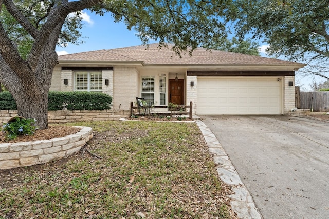 3305 Avenal Dr, Austin, TX 78738 - single story home with a garage, concrete driveway, brick siding, and roof with shingles