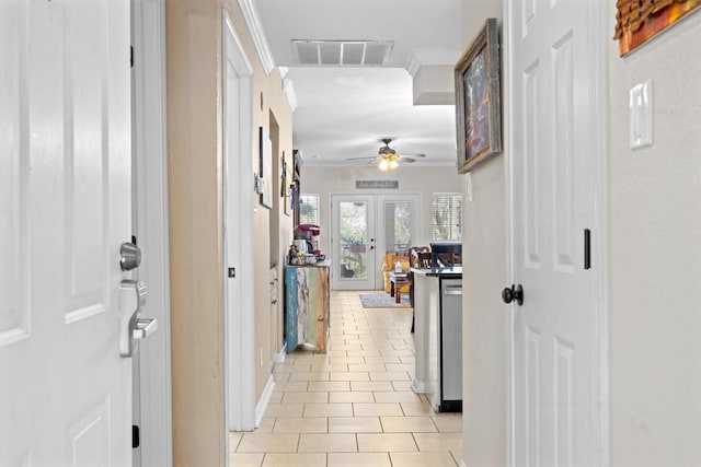 corridor with ornamental molding, french doors, visible vents, and light tile patterned floors