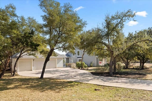 view of front of property featuring a garage and a front lawn