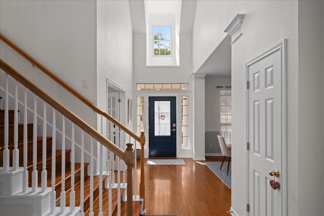 foyer featuring hardwood / wood-style floors and a high ceiling