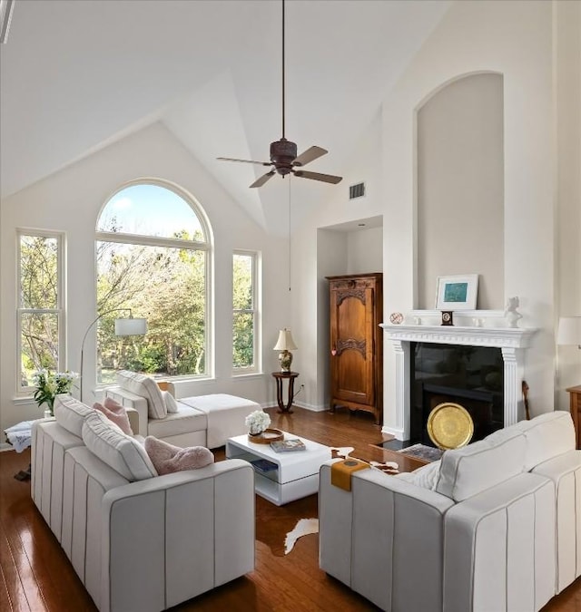 living room featuring ceiling fan, dark hardwood / wood-style flooring, and high vaulted ceiling