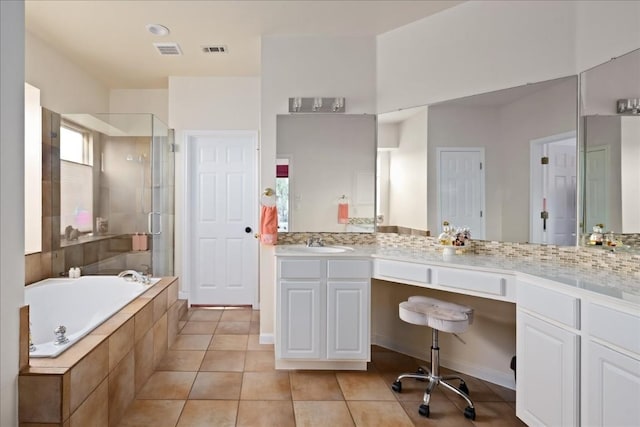 bathroom featuring vanity, plus walk in shower, tile patterned flooring, and a wealth of natural light