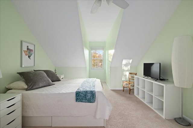 bedroom with light carpet, vaulted ceiling, and ceiling fan