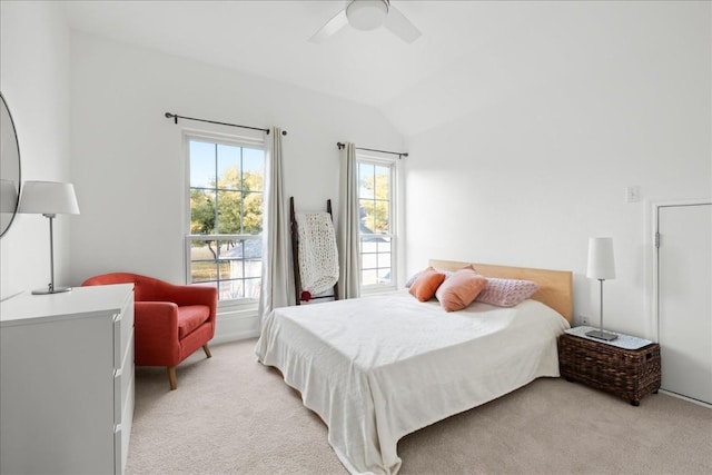 carpeted bedroom with vaulted ceiling and ceiling fan