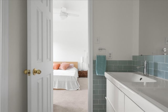 bathroom with vanity and tile walls