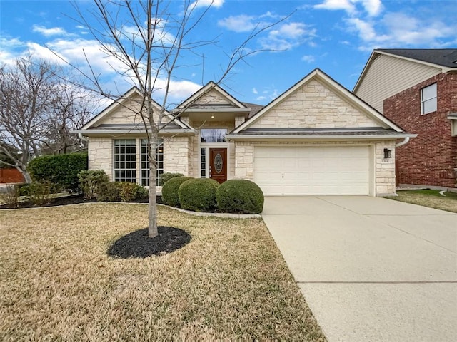 view of front of home featuring a garage and a front lawn