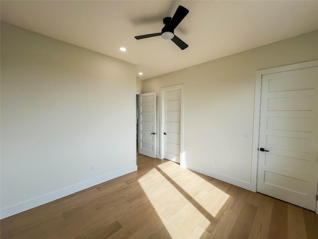 unfurnished bedroom featuring light hardwood / wood-style flooring and ceiling fan