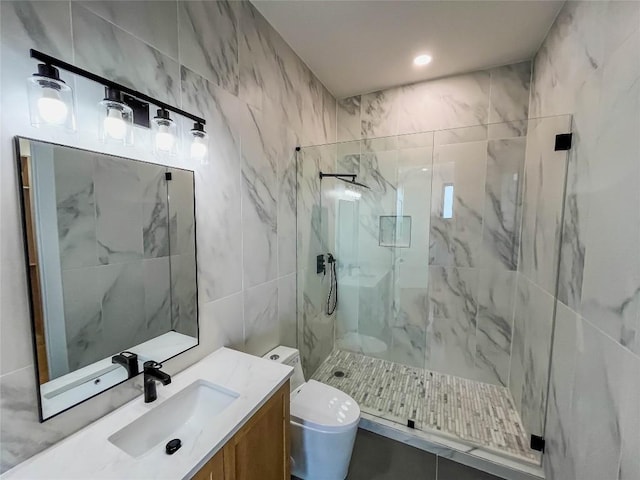 bathroom featuring vanity, a shower with shower door, tile walls, and toilet