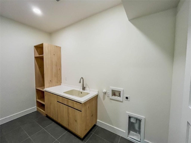 clothes washing area featuring sink, hookup for a washing machine, dark tile patterned flooring, hookup for a gas dryer, and hookup for an electric dryer