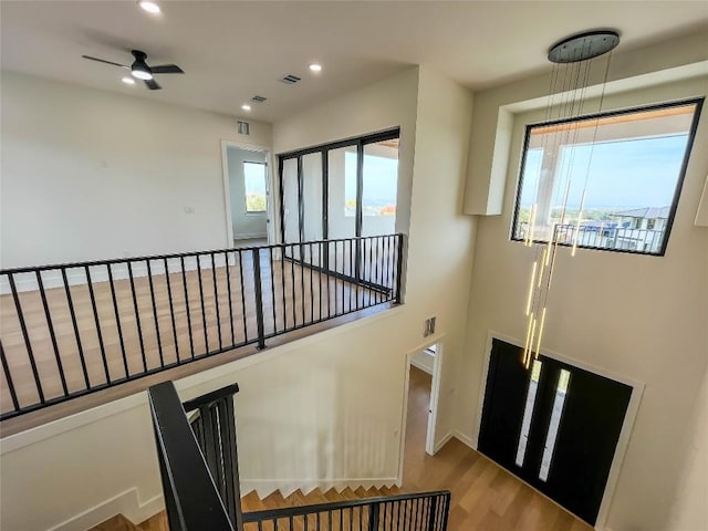 interior space with hardwood / wood-style flooring, a wealth of natural light, and ceiling fan