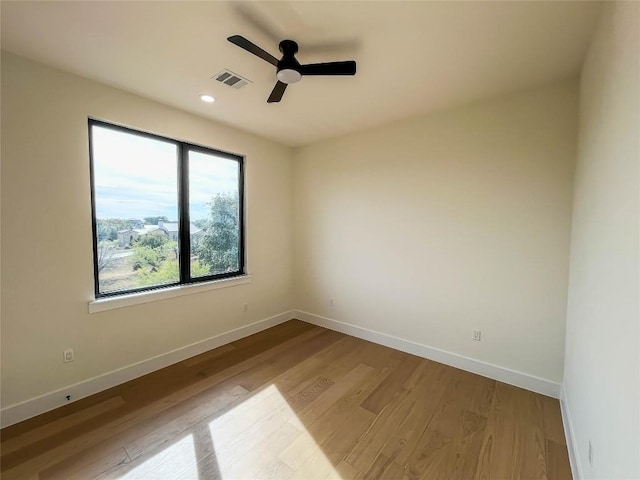 spare room featuring ceiling fan and light wood-type flooring