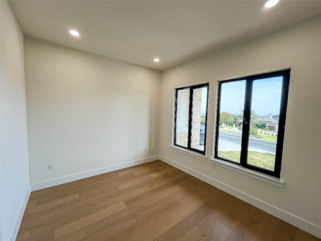 unfurnished room with light hardwood / wood-style floors