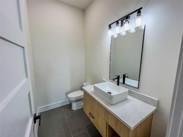 bathroom with vanity, toilet, and tile patterned flooring