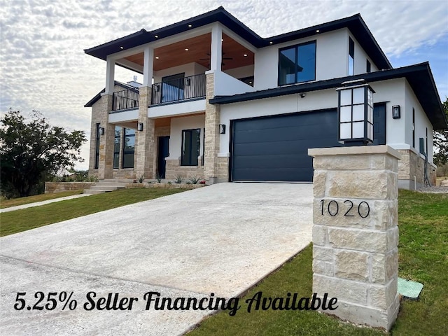 1020 Mountain Leather Dr, Horseshoe Bay, TX 78657 - modern home featuring a balcony, stucco siding, concrete driveway, and stone siding