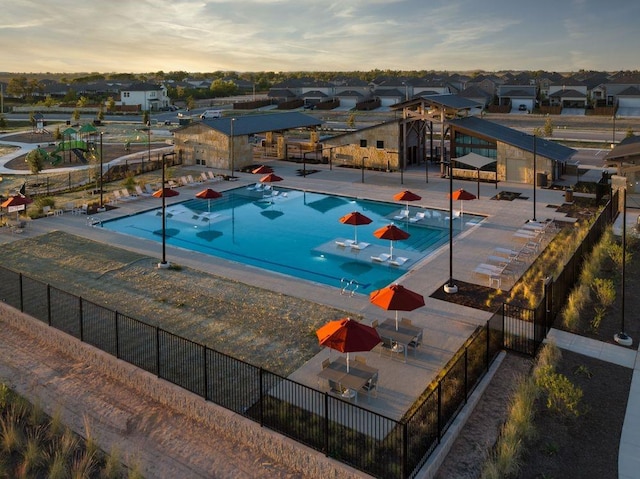 view of pool at dusk