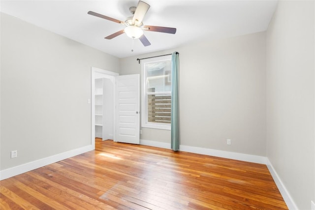 unfurnished bedroom with ceiling fan and light wood-type flooring