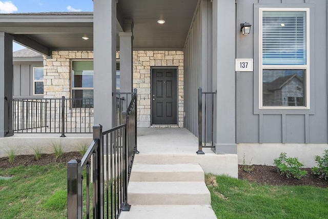 137 Tenny Ln, Kyle, TX 78640 - view of exterior entry with stone siding, board and batten siding, and a porch