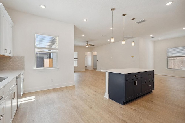 137 Tenny Ln, Kyle, TX 78640 - kitchen featuring white cabinetry, light wood finished floors, light countertops, a ceiling fan, and baseboards