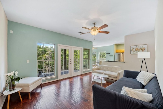 living room with hardwood / wood-style flooring, ceiling fan, and french doors