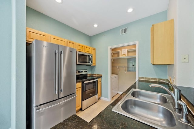 kitchen with separate washer and dryer, sink, stainless steel appliances, and light brown cabinets