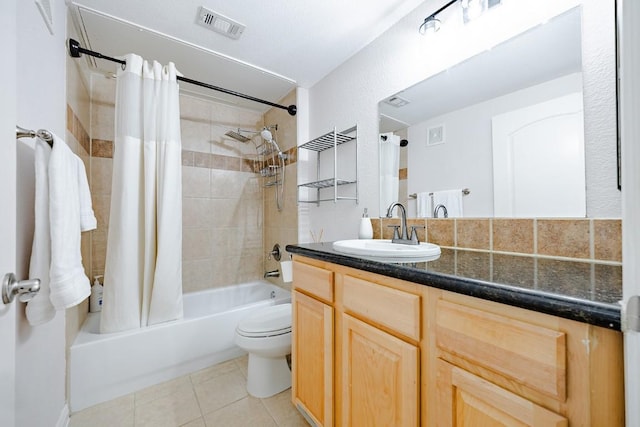 full bathroom featuring tile patterned flooring, shower / tub combo, vanity, and toilet