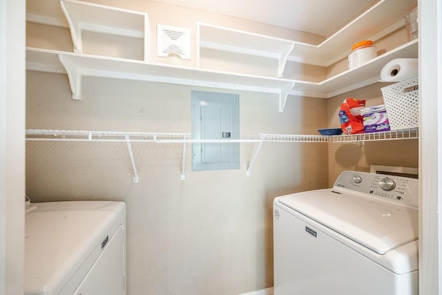 clothes washing area with electric panel and washing machine and clothes dryer