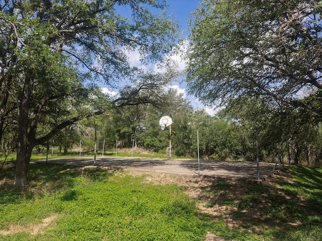 view of yard featuring basketball hoop