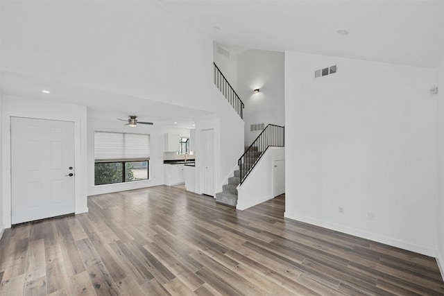 2018 W Rundberg Ln Unit 9D, Austin, TX 78758 - unfurnished living room with hardwood / wood-style flooring and high vaulted ceiling
