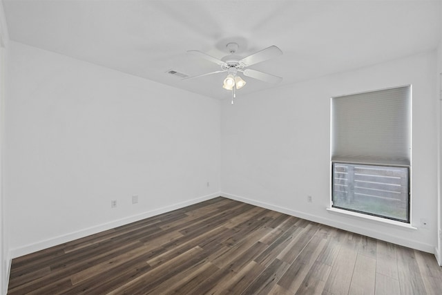 2018 W Rundberg Ln Unit 9D, Austin, TX 78758 - spare room featuring dark wood-style floors, a ceiling fan, and baseboards