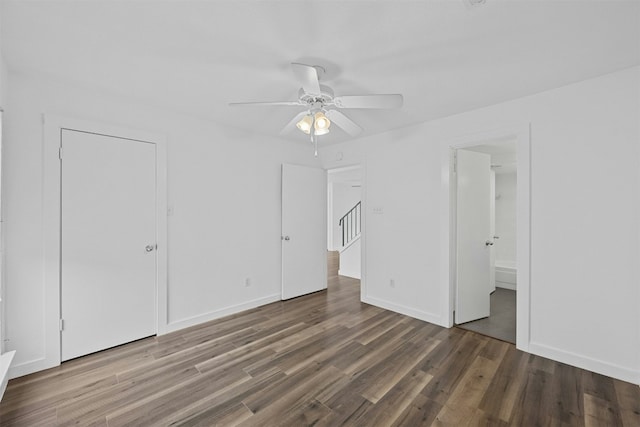2018 W Rundberg Ln Unit 9D, Austin, TX 78758 - unfurnished bedroom with wood finished floors, connected bathroom, baseboards, and a ceiling fan