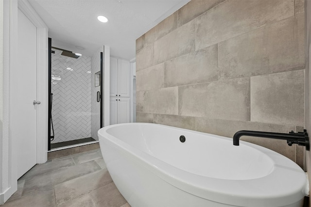 2018 W Rundberg Ln Unit 9D, Austin, TX 78758 - full bathroom with a freestanding bath and a shower stall