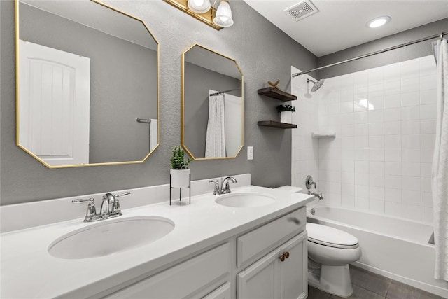 full bathroom featuring vanity, tile patterned floors, toilet, and shower / bath combo with shower curtain