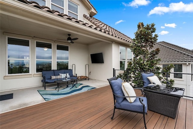 wooden deck featuring outdoor lounge area and ceiling fan