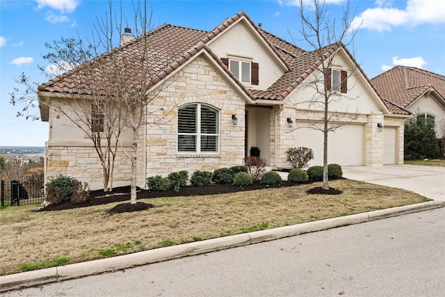 view of front of home featuring a garage and a front yard