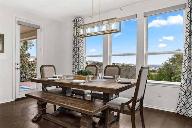 dining space featuring dark hardwood / wood-style floors and a chandelier