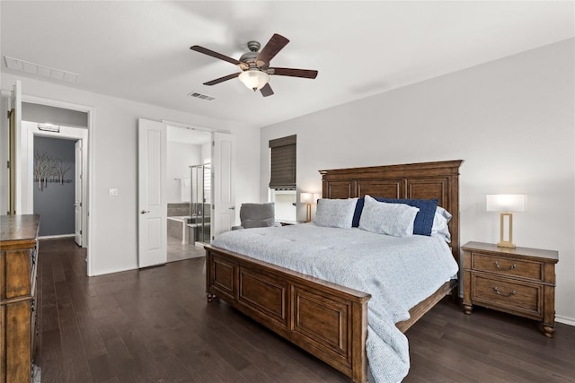 bedroom with ensuite bathroom, dark hardwood / wood-style floors, and ceiling fan