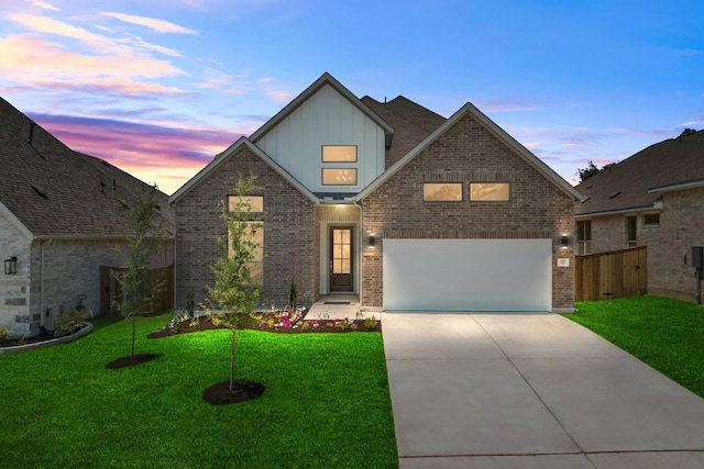 337 Five Mile Creek Way, Kyle, TX 78640 - view of front of home featuring board and batten siding, concrete driveway, and brick siding