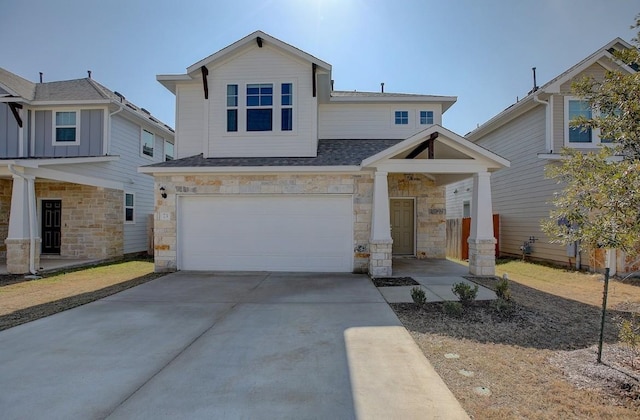 view of front of house featuring concrete driveway, a garage, stone siding, and roof with shingles