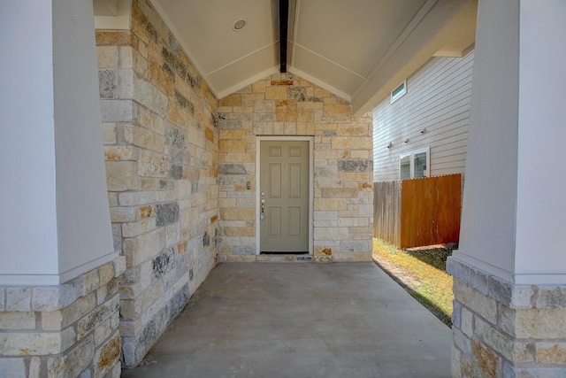 doorway to property featuring fence