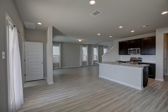 kitchen featuring visible vents, light wood finished floors, and stainless steel appliances