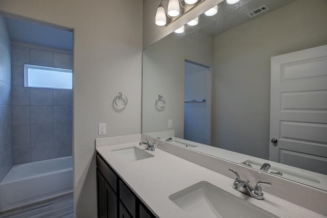 bathroom with double vanity, visible vents, and a sink