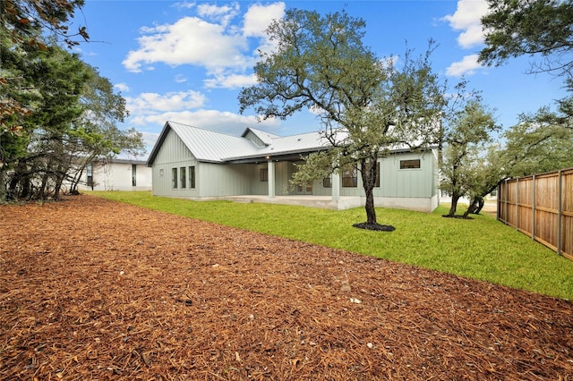 rear view of property with a yard and a patio